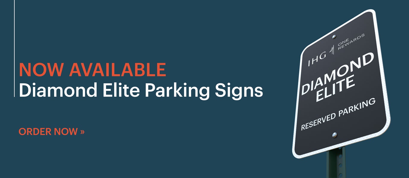 Slideshow Slide: Black metal IHG parking sign outdoors on a pole. Text reads: Now Available: Diamond Elite Parking Signs. Click to order now.